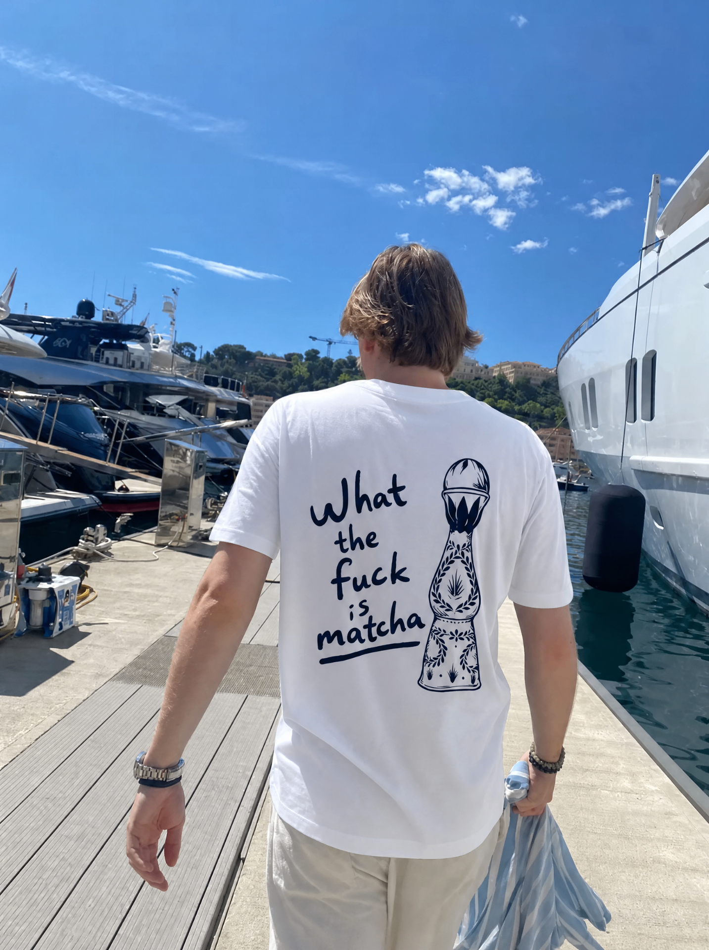 What the fuck is matcha tee on the Monaco marina between superyachts