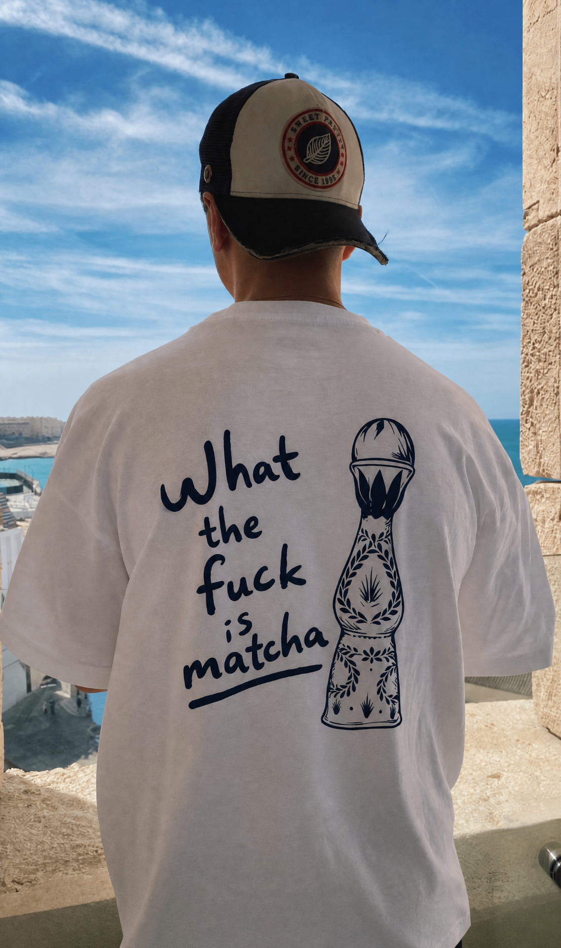 What the fuck is matcha tee on a seaside rooftop in a trucker cap